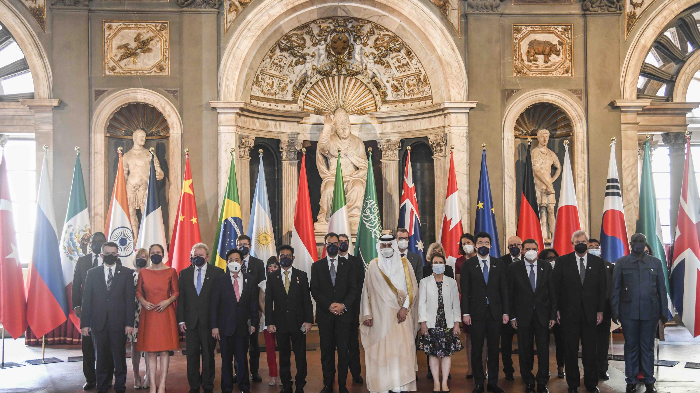 Agriculture ministers from the G20 stand together in front of their countries's flags