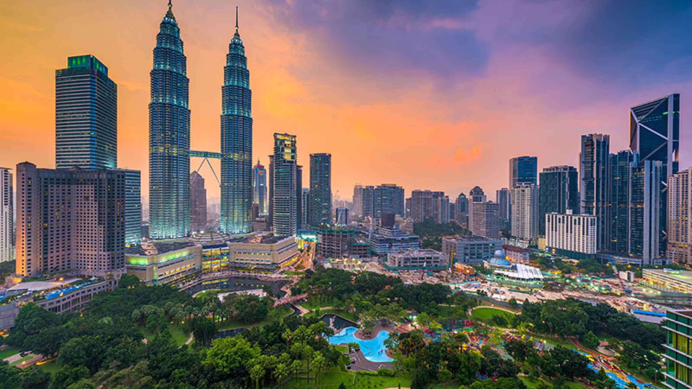 Kuala Lumpur, Malaysia skyline at dusk over the park.