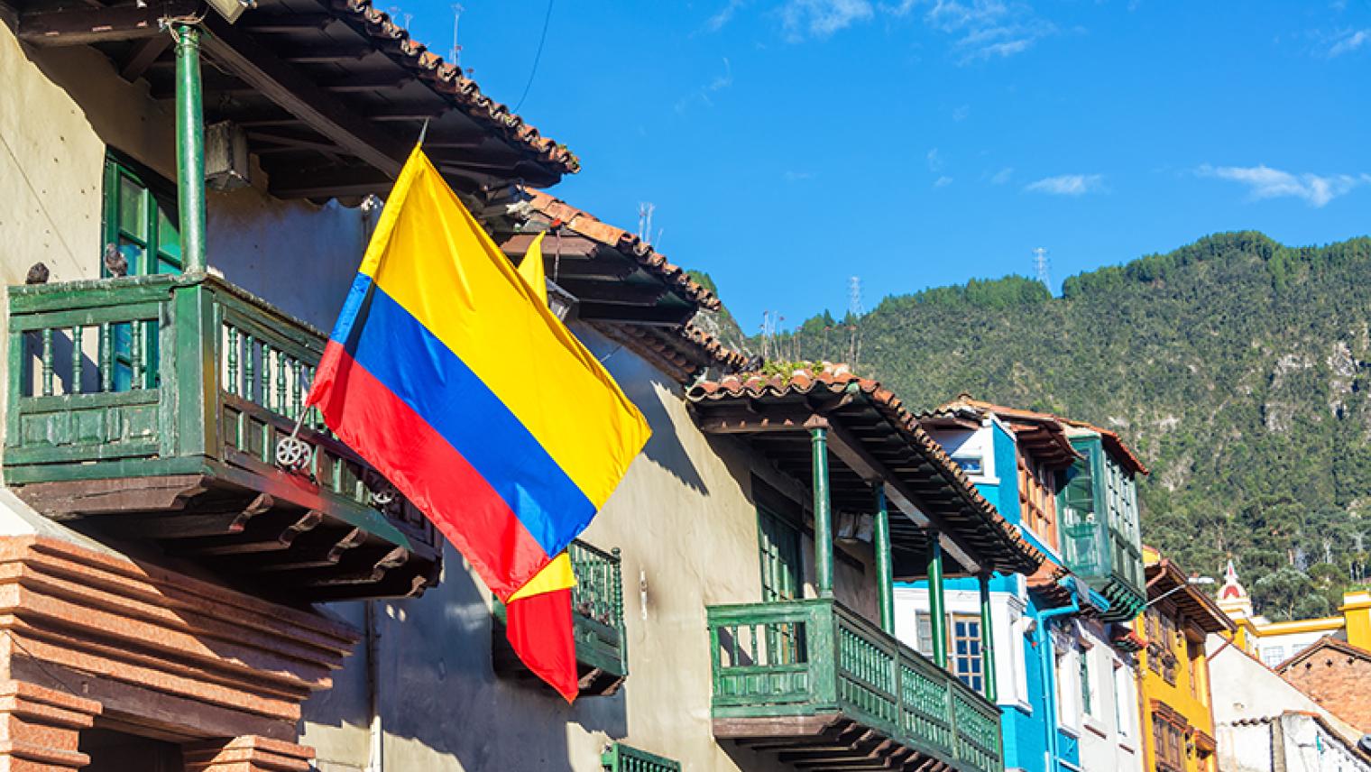 Historic buildings in Bogota with Colombian flag in foreground