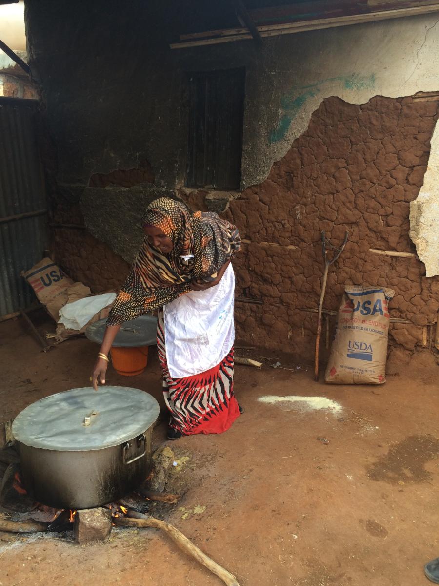 A parent volunteer uses USDA-supplied corn-soy blend to prepare a nutritious porridge for school children in eastern Ethiopia.