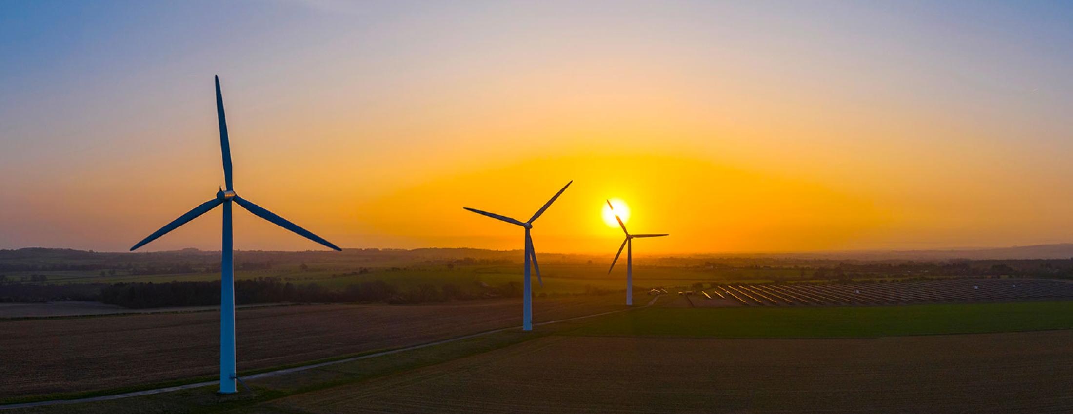 Image of power generating windmills among agricultural fields